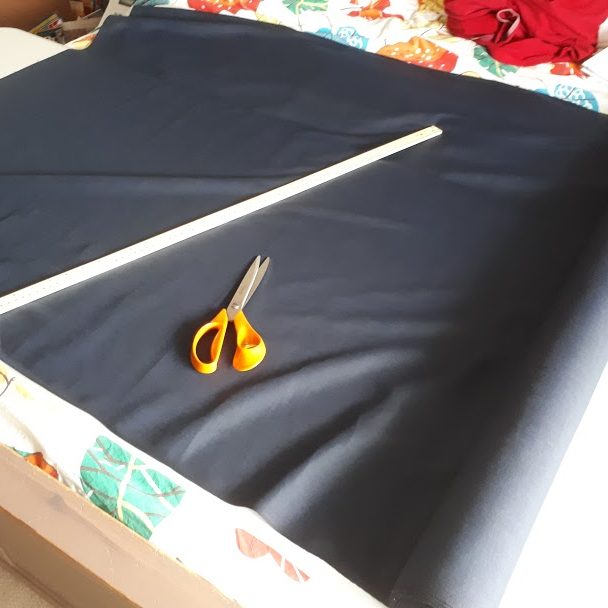 Fabric, scissors and measuring tape ready to cut the pattern