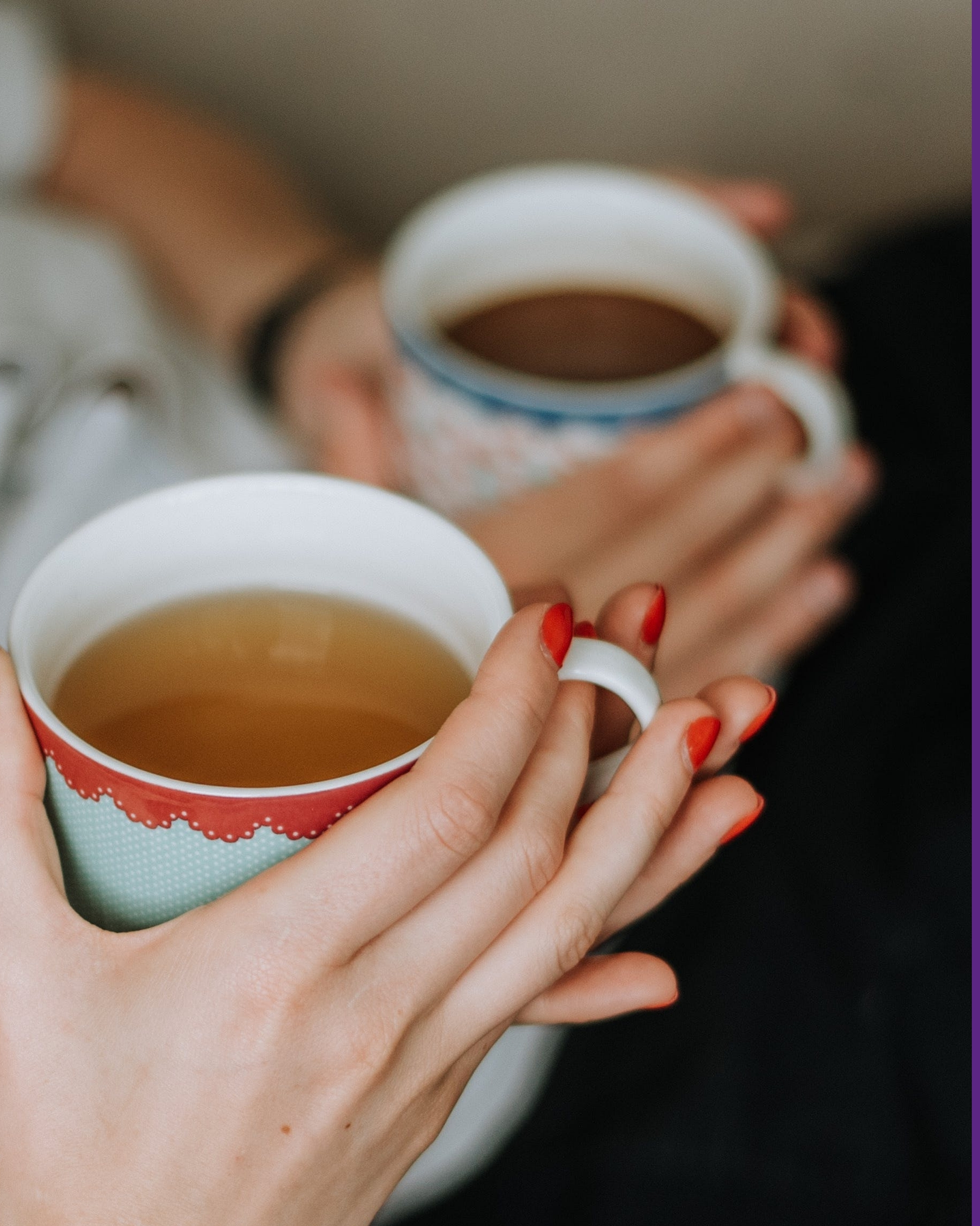 Two people each holding a cup of tea, creating a warm and relaxed atmosphere.